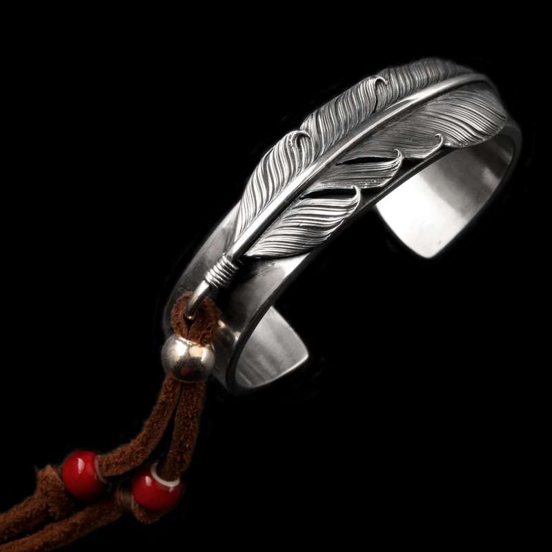 Feather Cuff Bracelet - Fine Silver - a broad feather-shaped cuff with carved barbs and a small cord-and-bead accent