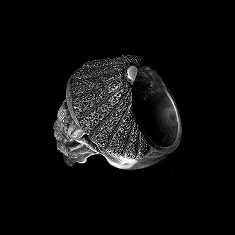 Side view of a heavy textured sterling silver biker ring