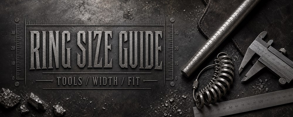 Ring size guide with mandrel, finger gauges, calipers and ruler on a dark silversmith workbench