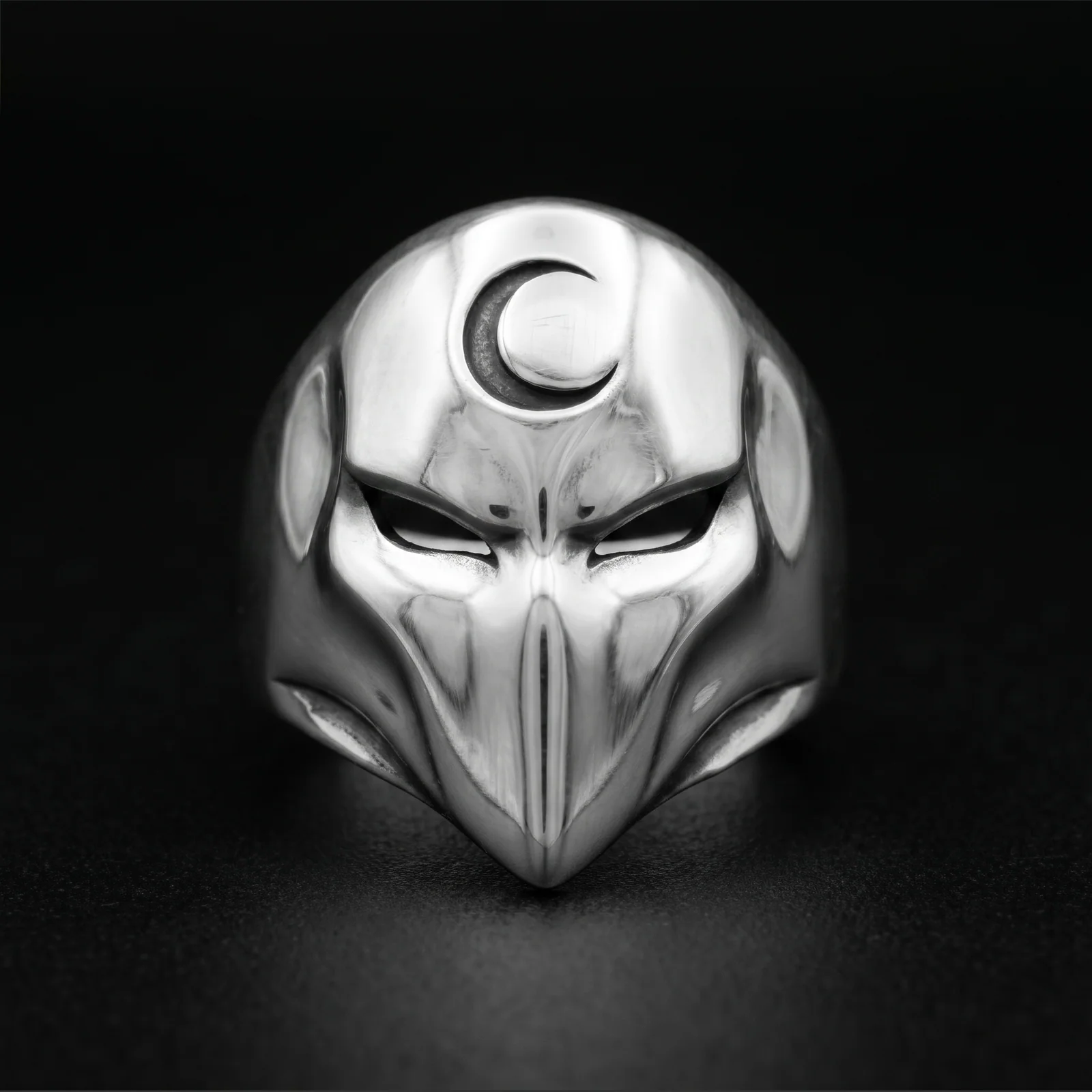 Crescent moon mask ring front view with slanted eye cutouts and a long pointed face