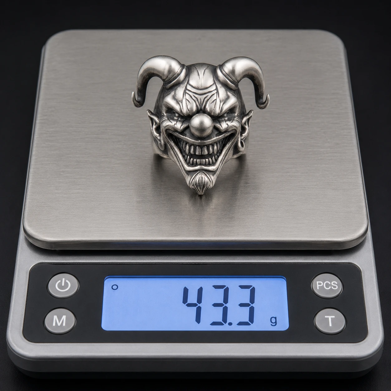 Horned jester ring sample on a digital scale reading 43.3 g