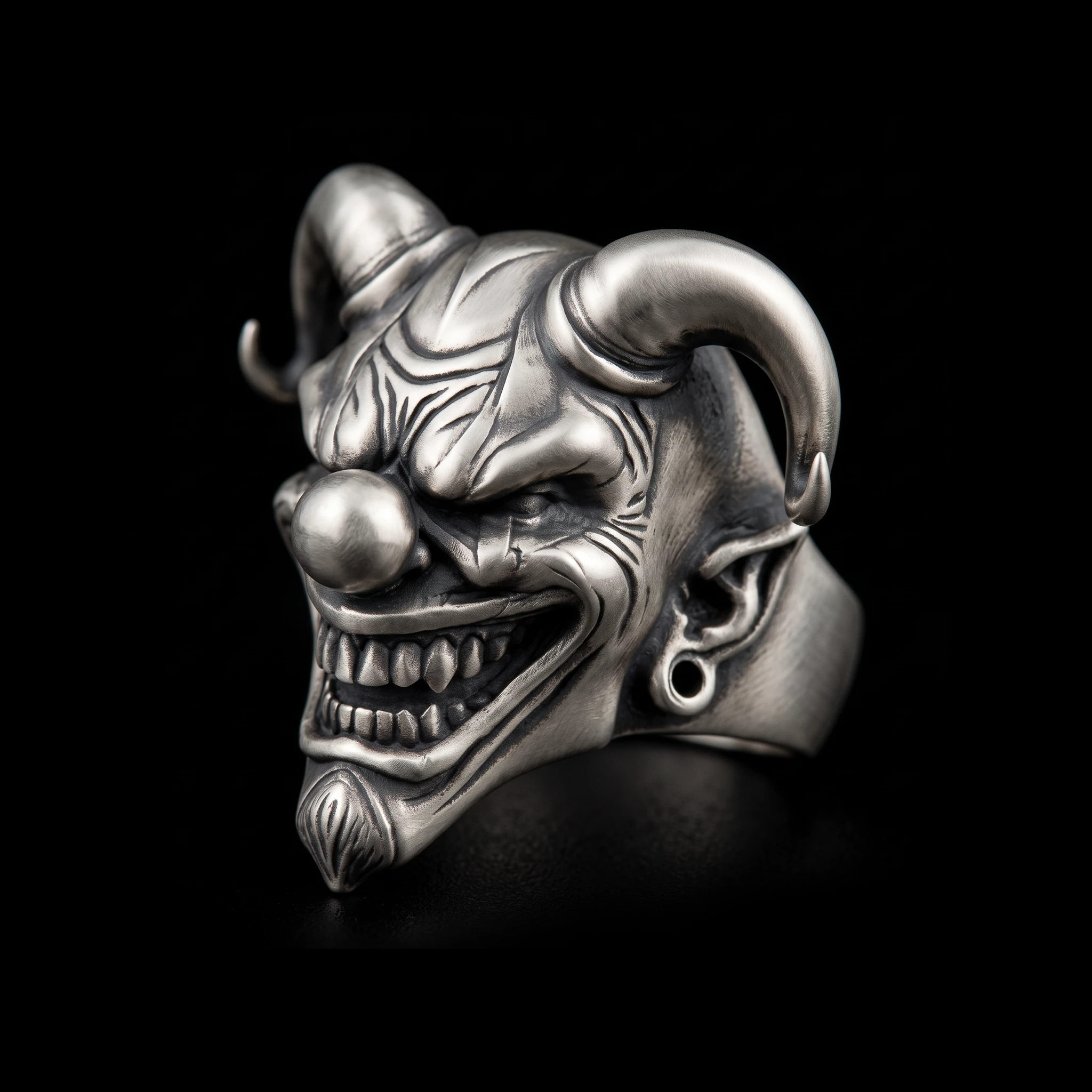 Horned jester ring three-quarter view on black background