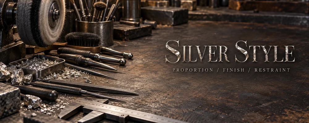 Silver style guide title on a metalsmith polishing bench with tools and raw silver
