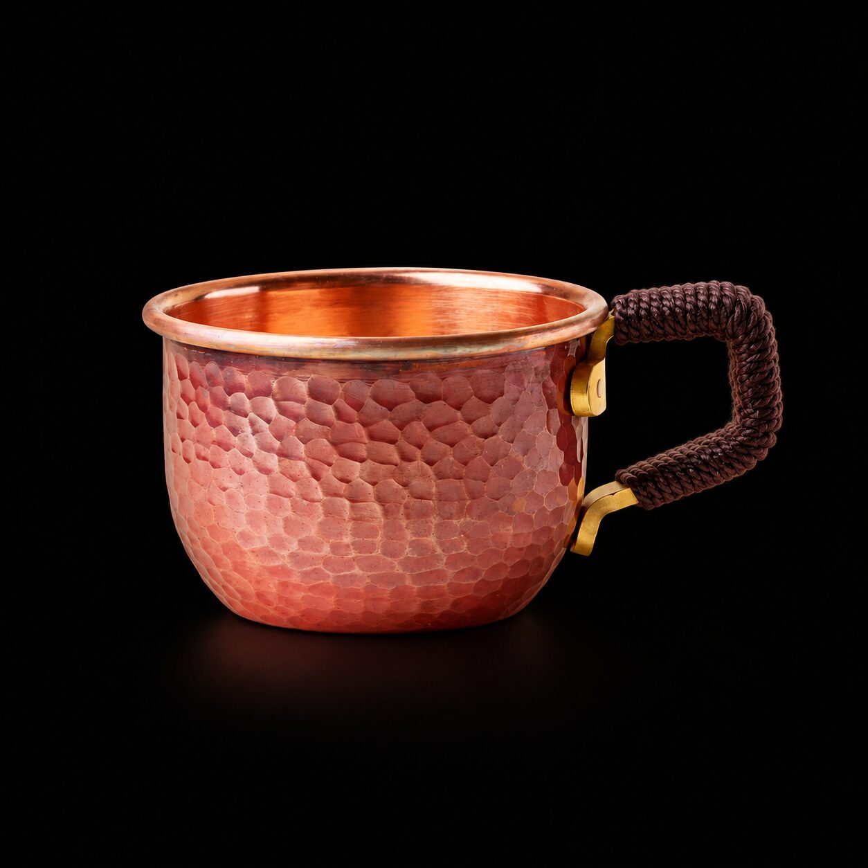 Hand-hammered red-copper mini cup with cord-wrapped angular handle on black